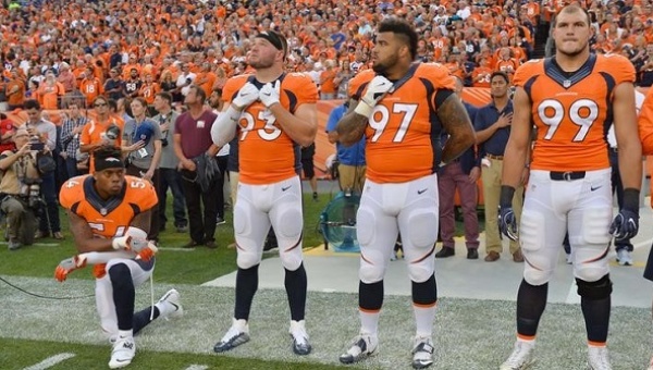 Denver Broncos linebacker Brandon Marshall kneels during the national anthem next to teammates before their game at Sports Authority Field at Mile High Sept. 8 2016