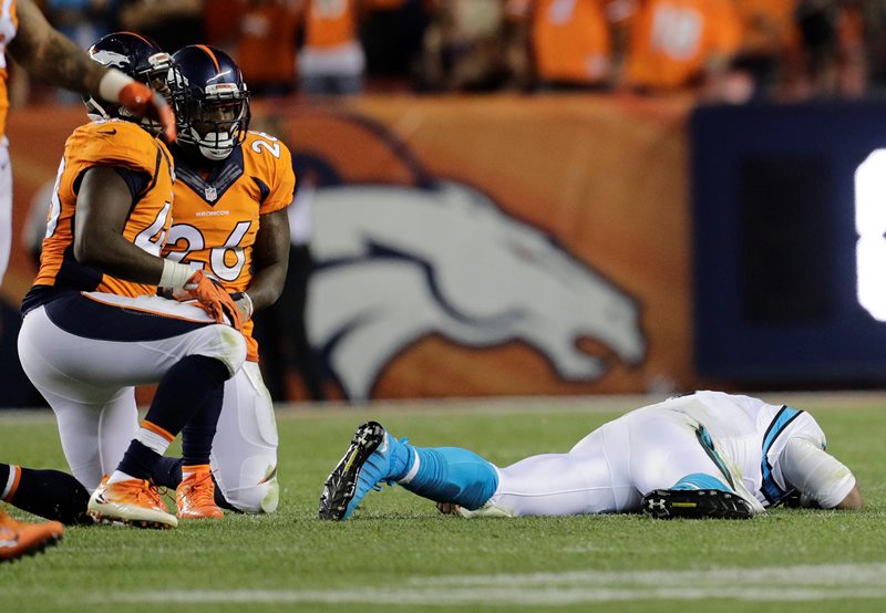 Carolina Panthers quarterback Cam Newton lies on the turf after a roughing the passer penalty on Denver Broncos free safety Darian Stewart during the second half of an NFL football game Thursday Sept. 8 2016 in Denver