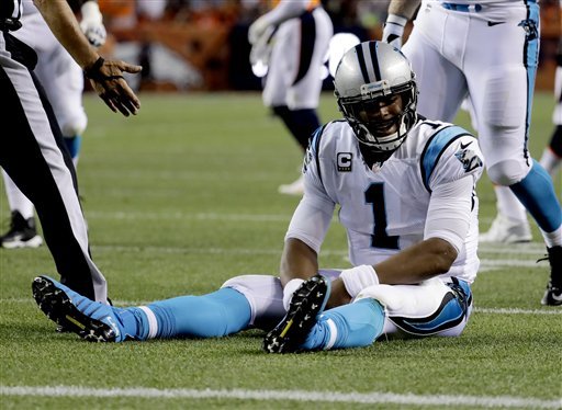 Carolina Panthers quarterback Cam Newton sits on the turf after being hit during the first half of an NFL football game against the Denver Broncos Thursday Sept. 8 2016 in Denver