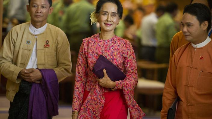 NLD leader Aung San Suu Kyi leaves after the new lower house parliamentary session in Naypyidaw in this file