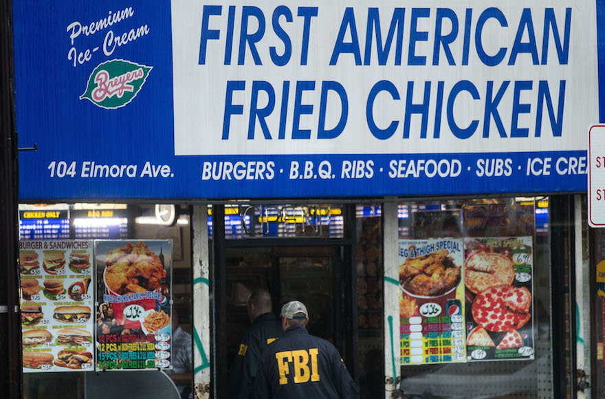 FBI officials entering a fried chicken store that is underneath the residence being investigated in connection to Saturday night's bombing in Manhattan Sept. 19 2016 in Elizabeth New Jersey