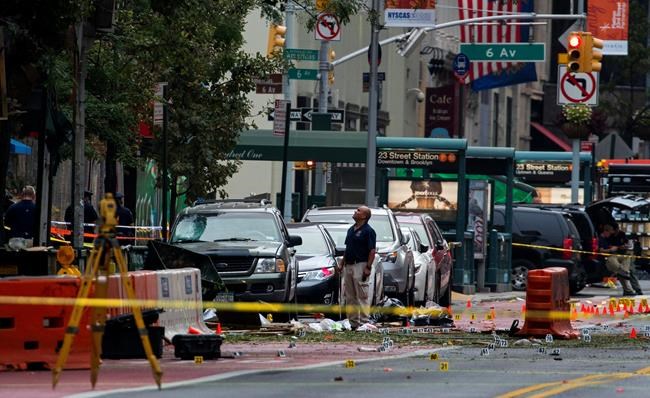 Crime scene investigators work at the scene of Saturday's explosion in Manhattan's Chelsea neighborhood in New York Sunday Sept. 18 2016