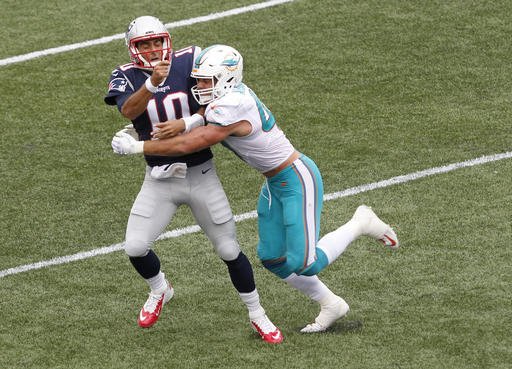 Miami Dolphins linebacker Kiko Alonso right hits New England Patriots quarterback Jimmy Garoppolo after he threw a pass during the first half of an NFL football game Sunday Sept. 18 2016 in Foxborough Mass. Garoppolo was injured on the play and