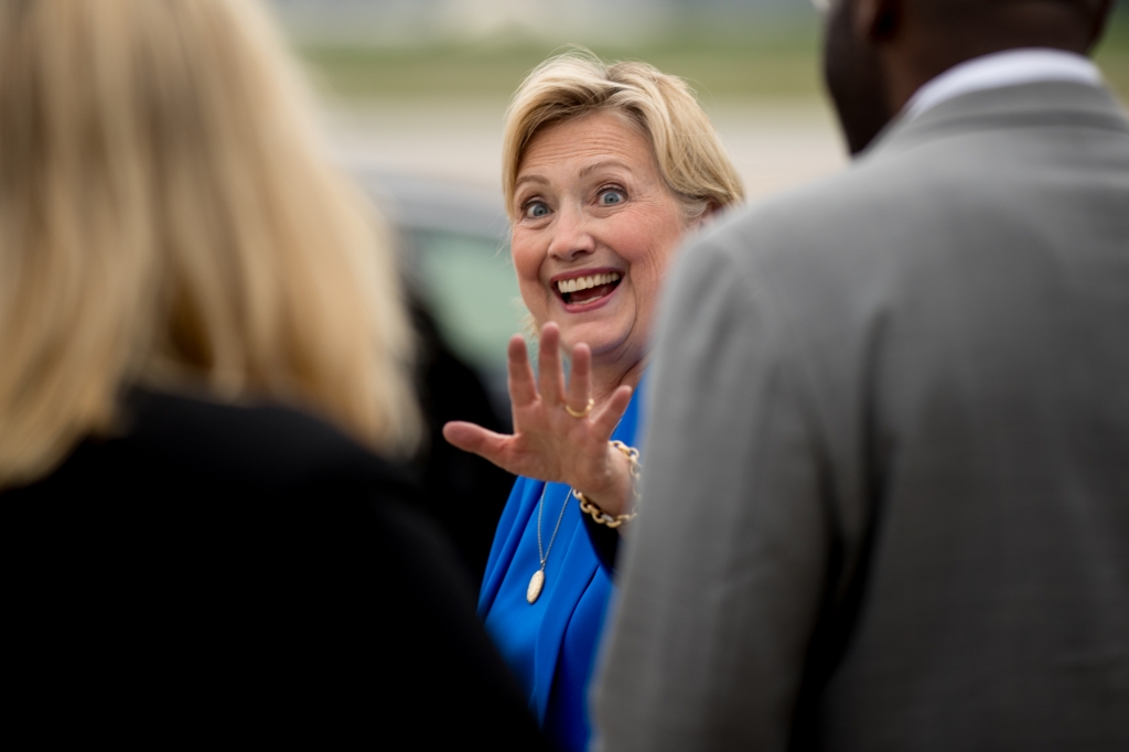 Democratic presidential candidate Hillary Clinton waves to greeters as she arrives at an airport in Kansas City Mo. on Sept. 8 2016