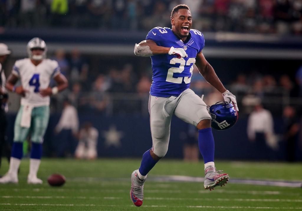 ARLINGTON TX- SEPTEMBER 11 Rashad Jennings #23 of the New York Giants celebrates as Dak Prescott #4 of the Dallas Cowboys looks on after the Giants beat the Cowboys 20-19 at AT&T Stadium