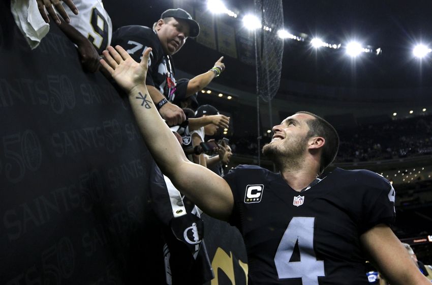 Oakland Raiders quarterback Derek Carr celebrates after a win against the New Orleans Saints during a game at the Mercedes Benz Superdome. The Raiders defeated the Saints 35-34