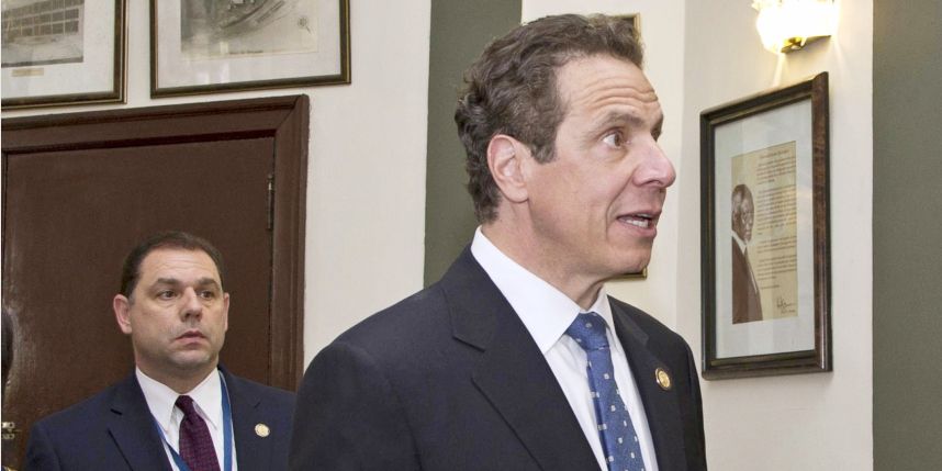 New York Governor Andrew Cuomo walks with his aide Joseph Percoco in the Hall of Fame before meetings in Havana Cuba April 2015