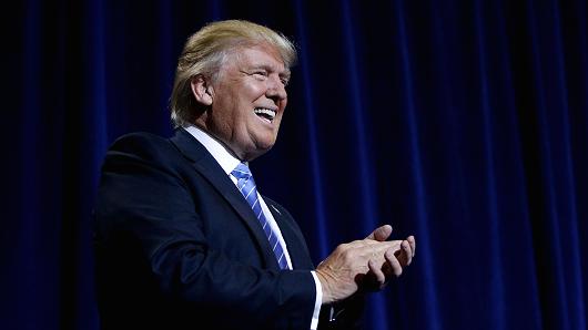 Republican presidential candidate Donald Trump applauds the crowd as he speaks to supporters about his Immigration Policy during a campaign rally