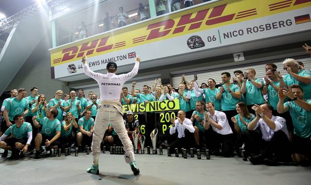 Mercedes driver Nico Rosberg of Germany celebrates with his team after winning the Singapore Formula One Grand Prix on the Marina Bay City Circuit Singapore Sunday Sept. 18 2016