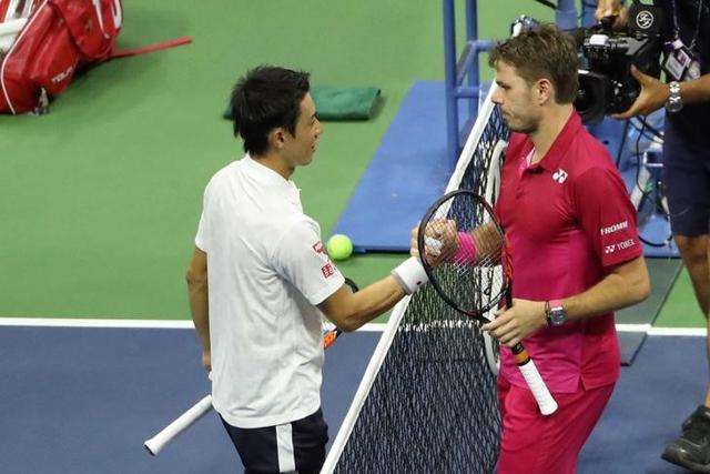 Nishikori and Wawrinka shake hands at the net after the match