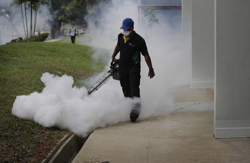 A pest control worker fumigates drains at a local housing estate where the latest case of Zika infections were reported from on Thursday Sept. 1 2016 in Singapore. Scientists trying to predict the future path of Zika say that 2.6 billion people living