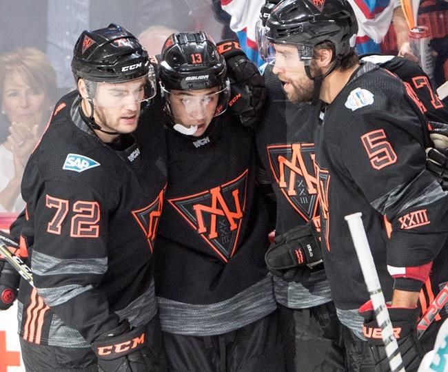 Team North America's Johnny Gaudreau celebrates his second goal with teammates Jonathan Drouin and Aaron Ekblad during third period pre-tournament World Cup of Hockey action Sunday