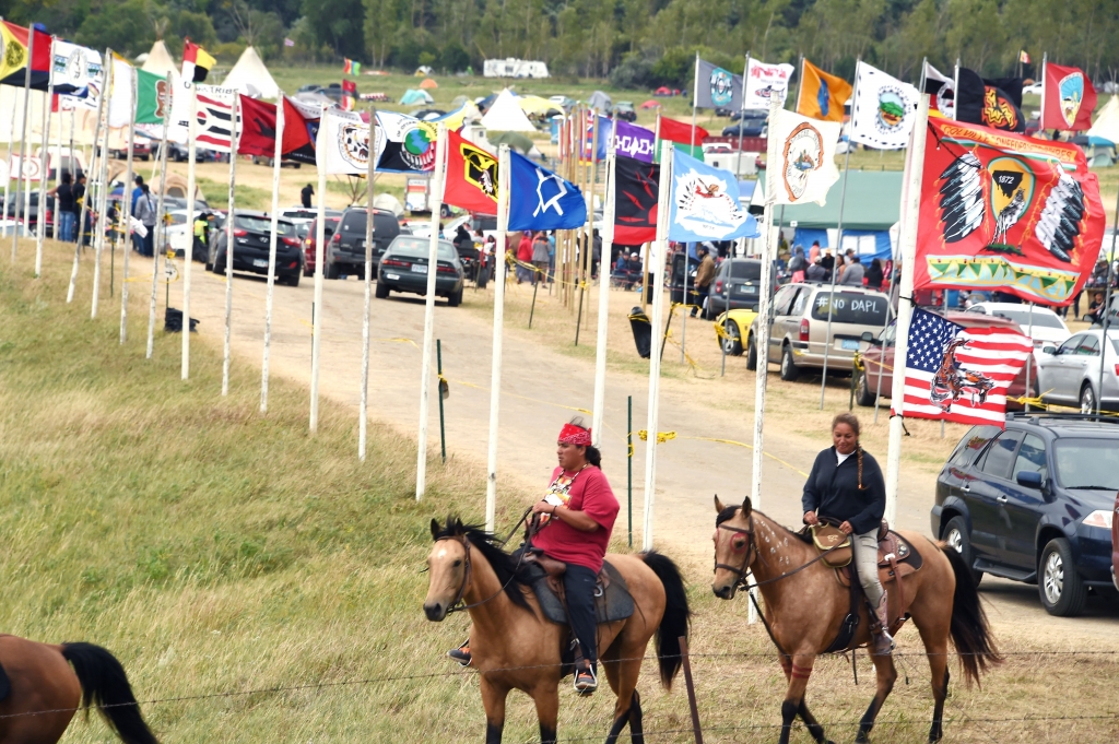 Flags of Native American tribes from across the US and Canada line the entrance to a protest encampment near Cannon Ball North Dakota where members of the Standing Rock Sioux Tribe and their supporters have gather to voice their opposition to the Dakota