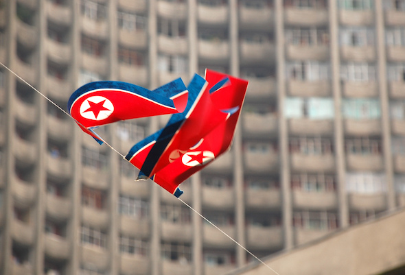 North Korean flags wave near an apartment building in Pyongyang