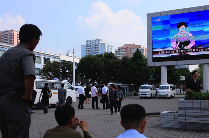 North Koreans watch a news report regarding a nuclear test on a large screen outside the Pyongyang Station