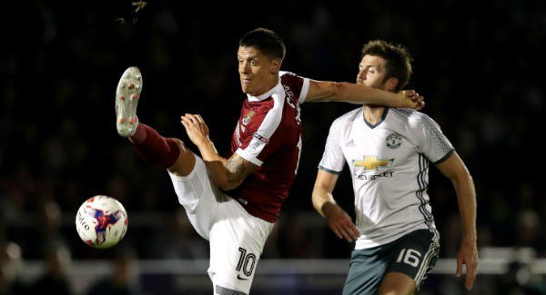 Northampton Town's Alex Revell and Manchester United's Michael Carrick in action at Sixfields Stadium