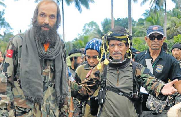 HORROR ORDEAL Moro National Liberation Front leader Nur Misuari front right escorts hostage Kjartan Sekkingstad after he was freed from the Abu Sayyaf Islamist militant group in the Philippines at the weekend