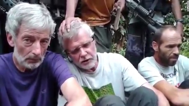 A still image taken from a video released by Abu Sayyaf militant kidnappers shows Canadians Robert Hall and John Ridsdel. The third male hostage is Norwegian Kjartan Sekkingstad