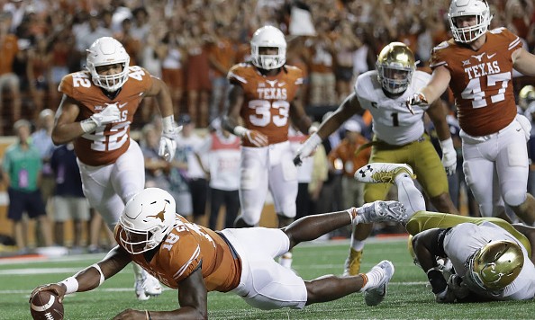 AUSTIN TX- SEPTEMBER 04 Tyrone Swoopes #18 of the Texas Longhorns dives for the game-winning touchdown in the second overtime against the Notre Dame Fighting Irish at Darrell K. Royal Texas Memorial Stadium