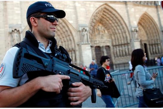 A French police officer patrols in front of Notre Dame cathedral in Paris Friday Sept. 9 2016. A failed attack involving a car loaded with gas canisters near Notre Dame Cathedral was spearheaded a group of women that included a 19-year-old whose writte