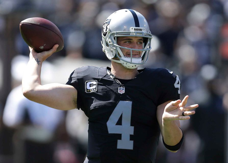 Oakland Raiders quarterback Derek Carr passes against