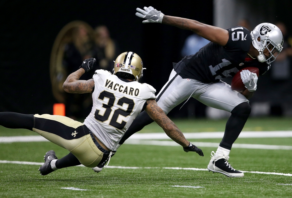 NEW ORLEANS LA- SEPTEMBER 11 Michael Crabtree #15 of the Oakland Raiders runs past Kenny Vaccaro #32 of the New Orleans Saints druing the second quarter at the Mercedes Benz Superdome