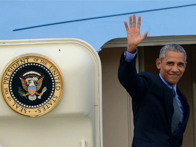 Barack Obama waves as he boards Air Force One following the closing ceremony of the Association of Southeast Asian Nations, at the Wattay International Airport in Vientiane