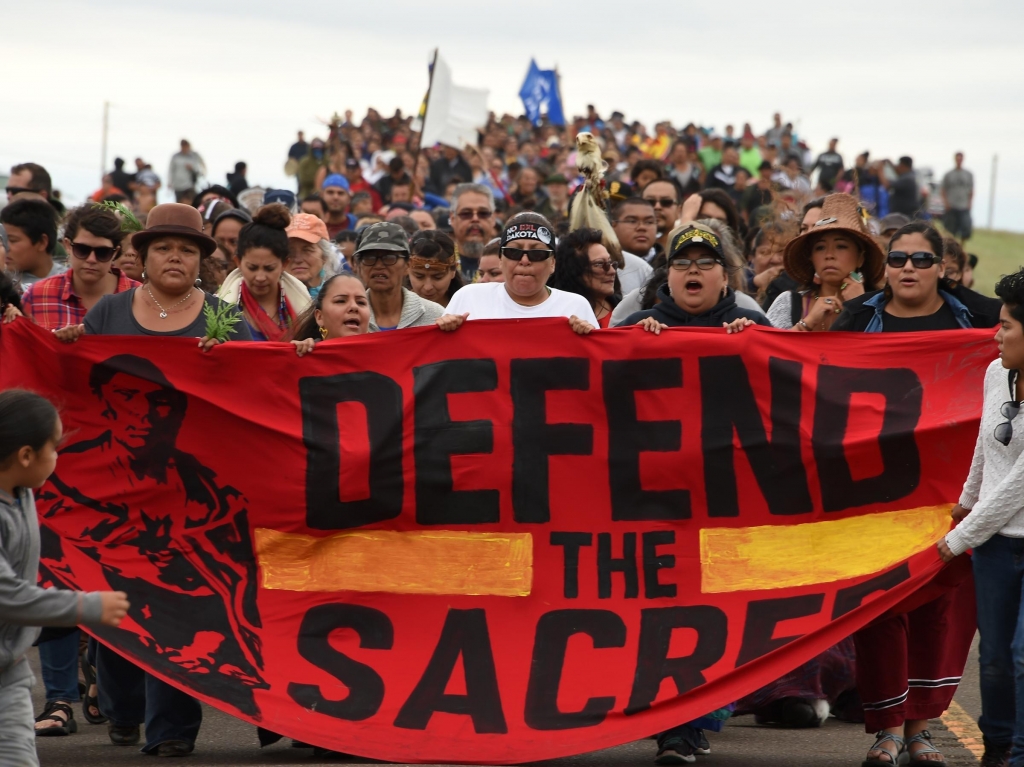 Native Americans march to a sacred site on Sunday that they say was disturbed by bulldozers working on the Dakota Access Pipeline near the encampment where hundreds of people have gathered to join the Standing Rock Sioux Tribe's protest