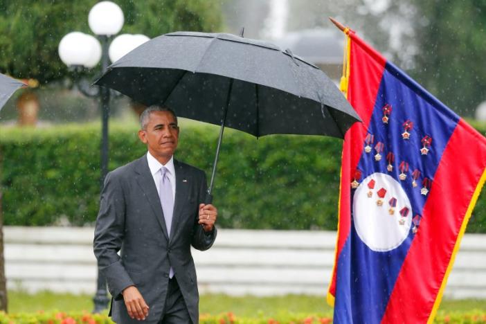 U.S. President Barack Obama walks to honour guard during a welcoming ceremony at the Presidential Palace in Vientiane Laos