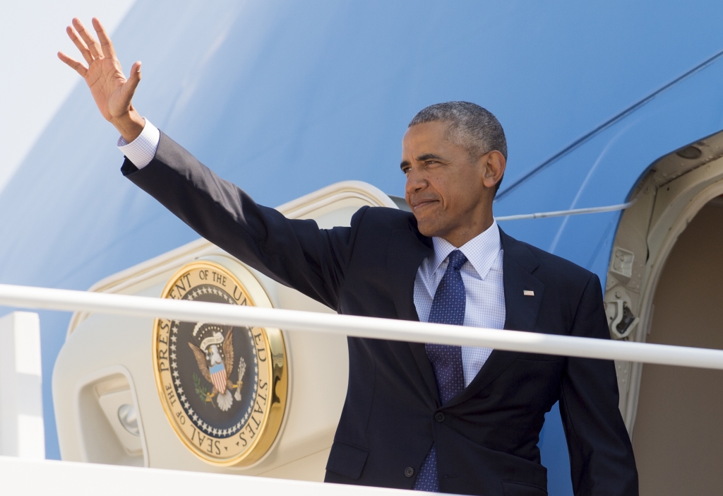 US President Barack Obama waves from Air Force One prior to departing from Andrews Air Force Base in Maryland