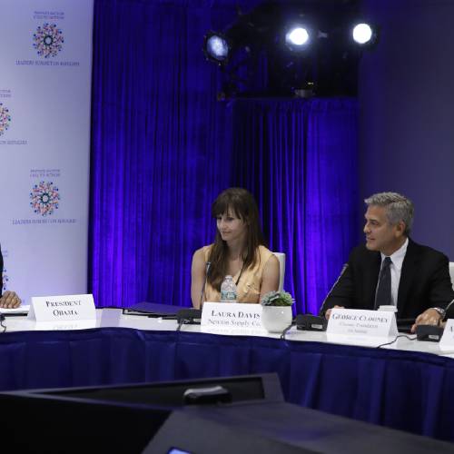 Obama joined by actor George Clooney his wife Amal Clooney right and Laura Davis of Newton Supply Co. center speaks at a CEO roundtable on the margins of the 71st session of the United Nations General Assembly at UN headqua