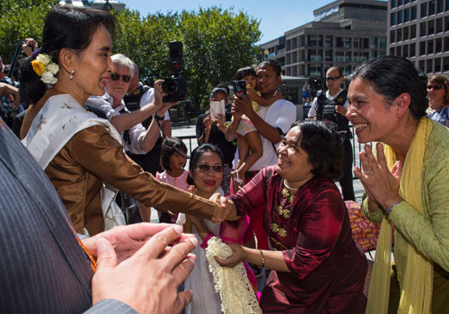 State Counselor Daw Aung San Suu Kyi greets supporters outside the Blair House prior to meeting with Secretary of State John Kerry on September 14 in Washington DC