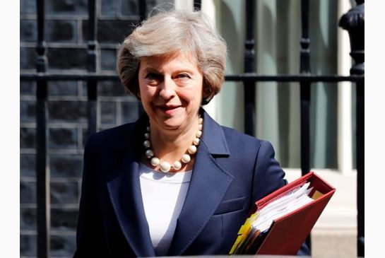 Britain's Prime Minister Theresa May leaves 10 Downing street for Prime Ministers Questions at the House of Parliament in London. ÔªøOn her first visit to China as Britain‚Äôs prime minister Theresa May will