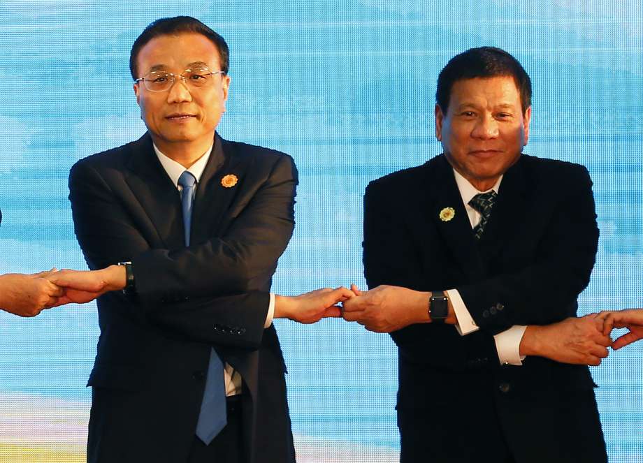 Chinese Premier Li Keqiang left and Philippine President Rodrigo Duterte link their hands during the ASEAN Plus Three summit in the ongoing 28th and 29th ASEAN Summits and other related summits at the National Convention Center Wednesday Sept. 7 2016