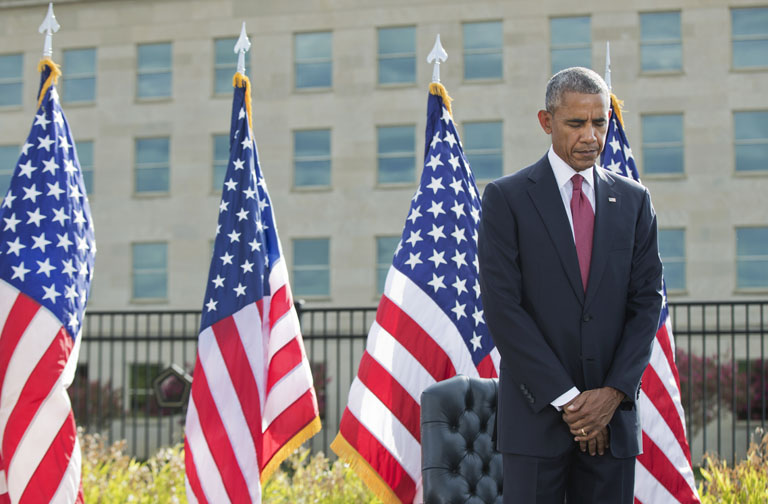 President Barack Obama bows as a moment of silence is observed during a memorial ceremony at the Pentagon in Washington to commemorate the 15th anniversary of the 9/11 terrorist attacks Sunday Sept. 11 2016