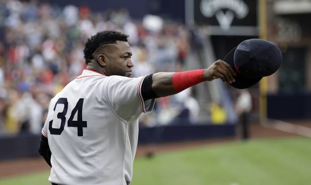 Boston Red Sox designated hitter David Ortiz tips his cap after receiving a surfboard from the San Diego Padres during a pregame ceremony at a baseball game Wednesday Sept. 7 2016 in San Diego