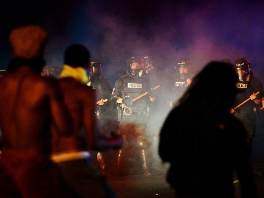 Officers stand in formation in front of protesters in Charlotte N.C. on Tuesday Sept. 20 2016