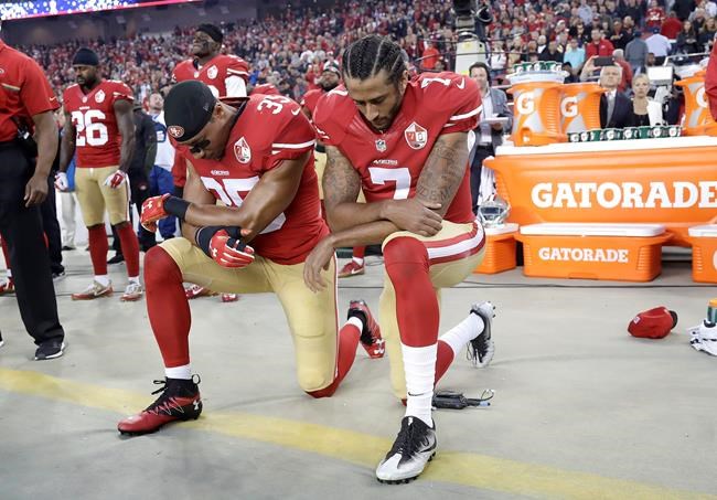 San Francisco 49ers safety Eric Reid and quarterback Colin Kaepernick kneel during the national anthem before an NFL football game against the Los Angeles Rams in Santa Clara Calif. Monday Sept. 12 2016