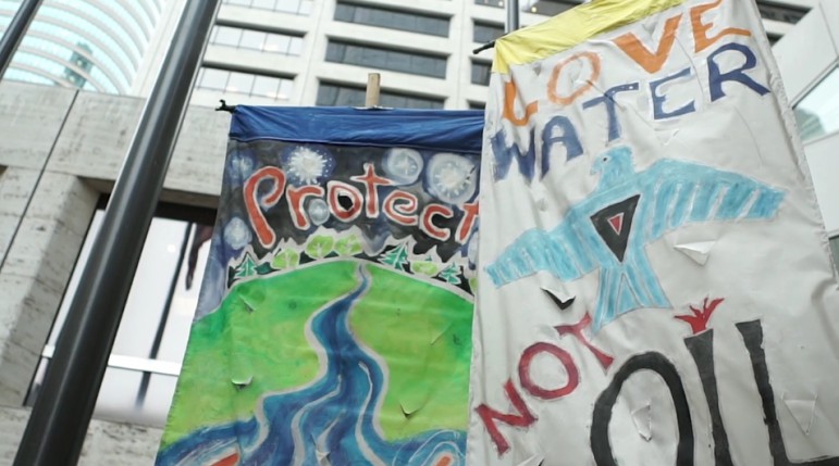 On Sep. 7 banners wave at US Bank Plaza to protest digging for the Dakota Access Pipeline