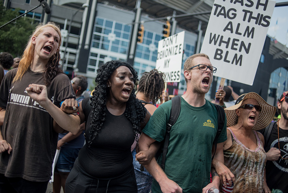 CHARLOTTE NC- SEPTEMBER 25 Demonstrators protest outside of Bank of America Stadium before an NFL football game between the Charlotte Panthers and the Minnesota Vikings