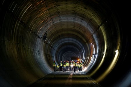 Members of the media interview an Israel Railways official during a media tour showcasing the last stages of the construction of a new high-speed railway between Tel Aviv and Jerusalem near Jerusalem