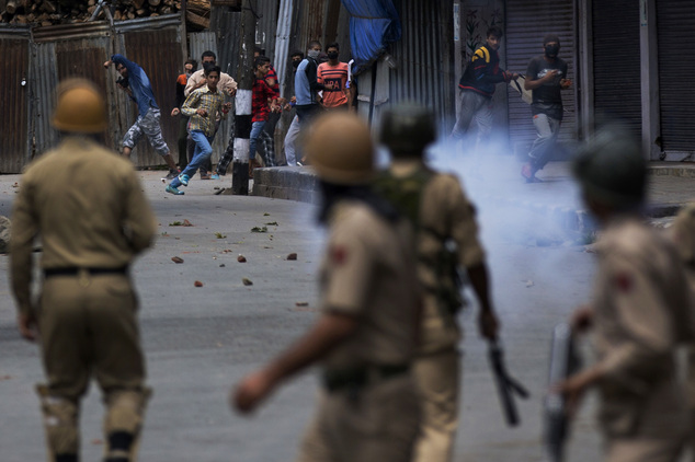 Kashmiri protesters face Indian policemen in Srinagar Indian controlled Kashmir Wednesday Aug. 31 2016. Fresh anti India protests and clashes erupted