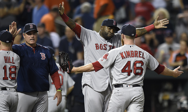 Boston Red Sox designated hitter David Ortiz center hugs closing pitcher Craig Kimbrel after defeating the Baltimore Orioles 5-3 in a baseball game to sweep