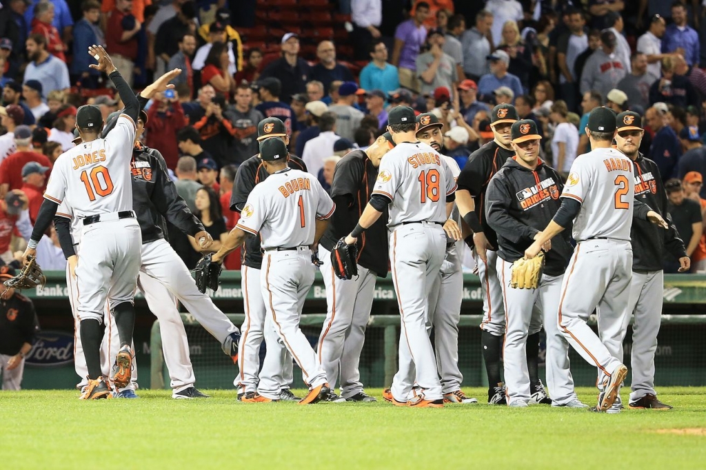 Orioles players celebrate after a 1-0 victory in Boston