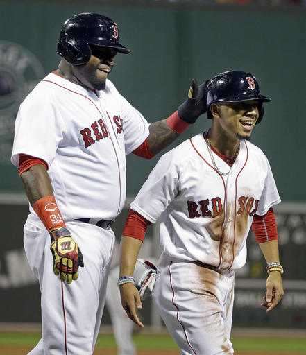 Boston Red Sox's David Ortiz left celebrates with Mookie Betts after they scored on a single by Hanley Ramirez in the first inning of a baseball game against the Baltimore Orioles at Fenway Park Monday Sept. 12 2016 in Boston. (AP