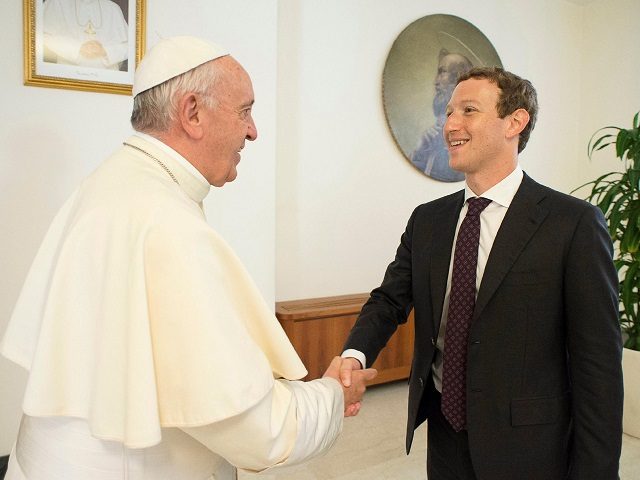 Pope Francis shakes hands with Facebook CEO Mark Zuckerberg during a meeting at the Vatican