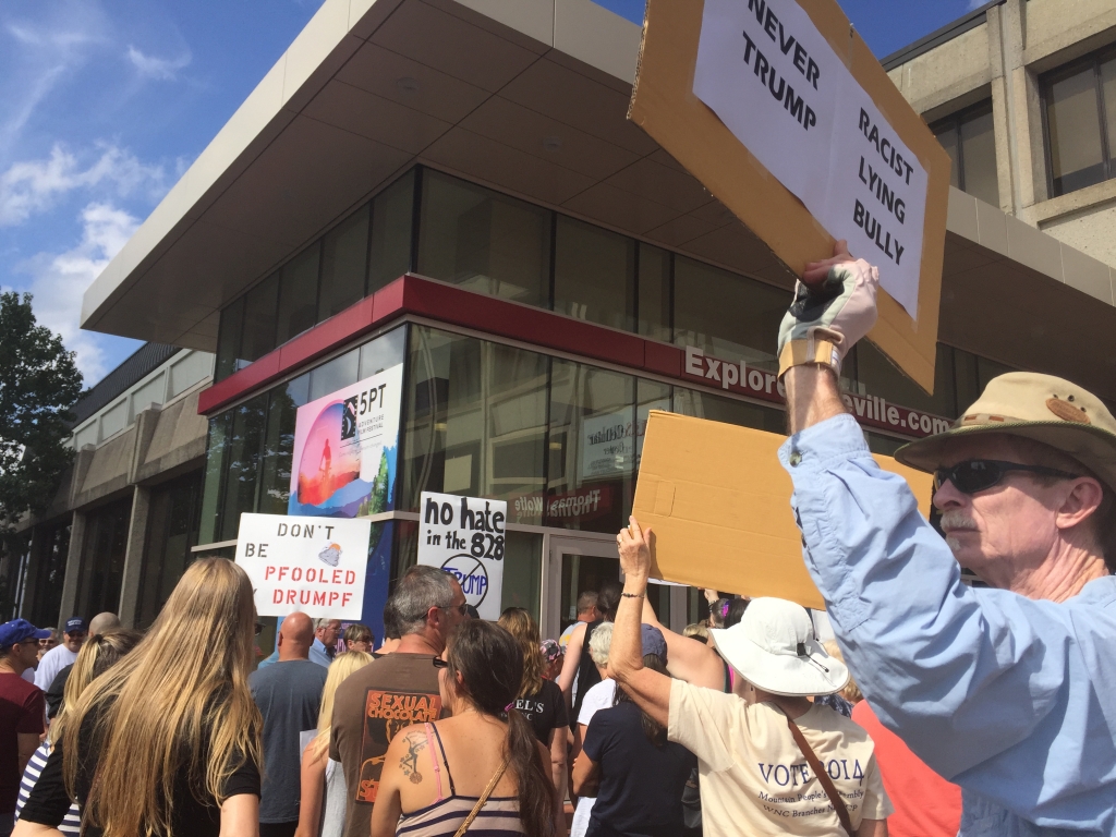 Outside the arena protesters held signs calling trump a racist