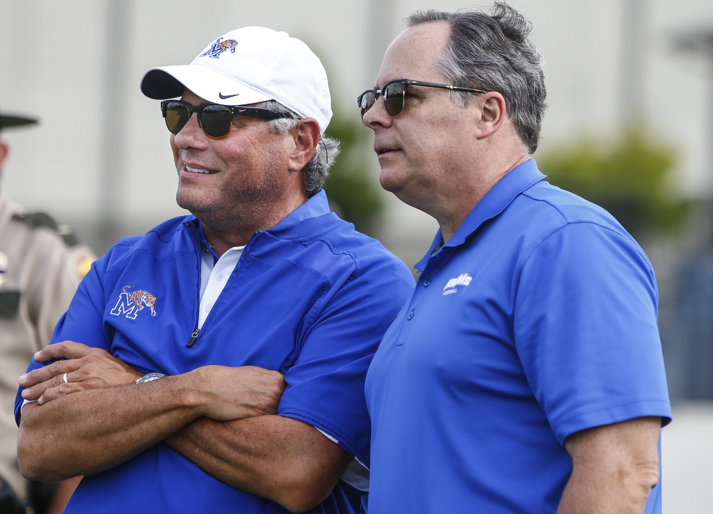 University of Memphis Athletic Director Tom Bowen and President David Rudd chat with each other during the Tigers scrimmage at Trinity Christian Academy in Jackson Tenn. last month. According to reports Friday by ESPN Memphis