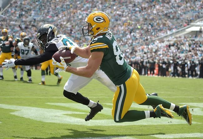 Green Bay Packers wide receiver Jordy Nelson catches a touchdown pass behind Jacksonville Jaguars defensive back Prince Amukamara left during the first half of an NFL football game in Jacksonville Fla. Sunday Sept. 11 2016. (AP