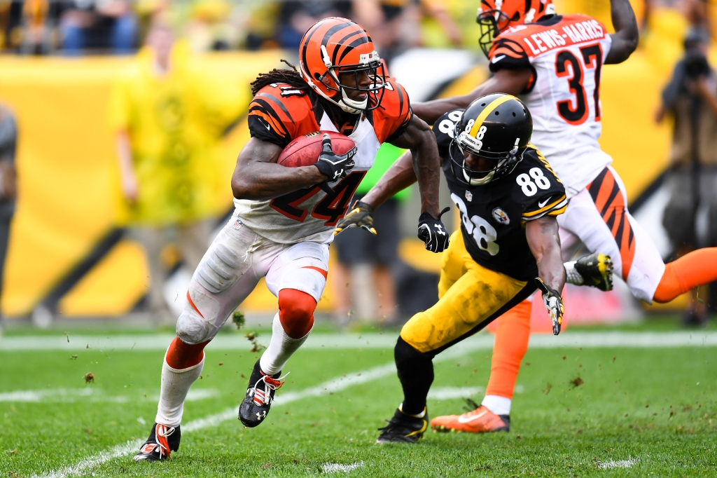 PITTSBURGH PA- SEPTEMBER 18 Adam Jones #24 of the Cincinnati Bengals returns a kick past Darrius Heyward Bey #88 of the Pittsburgh Steelers in the first half during the game at Heinz Field